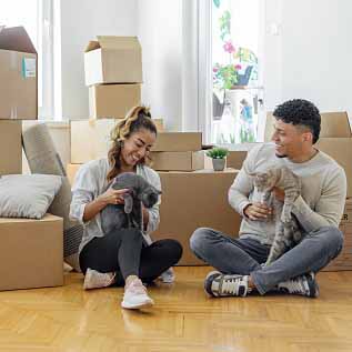 woman and man with pets in new home